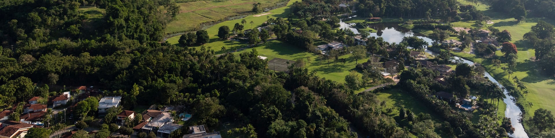 Aerial view from helicopter flight to green forest mountains