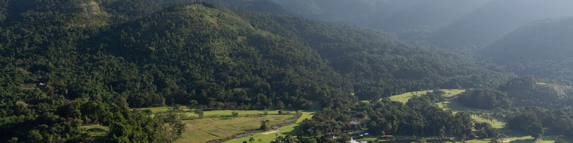 Aerial view from helicopter flight to green forest mountains