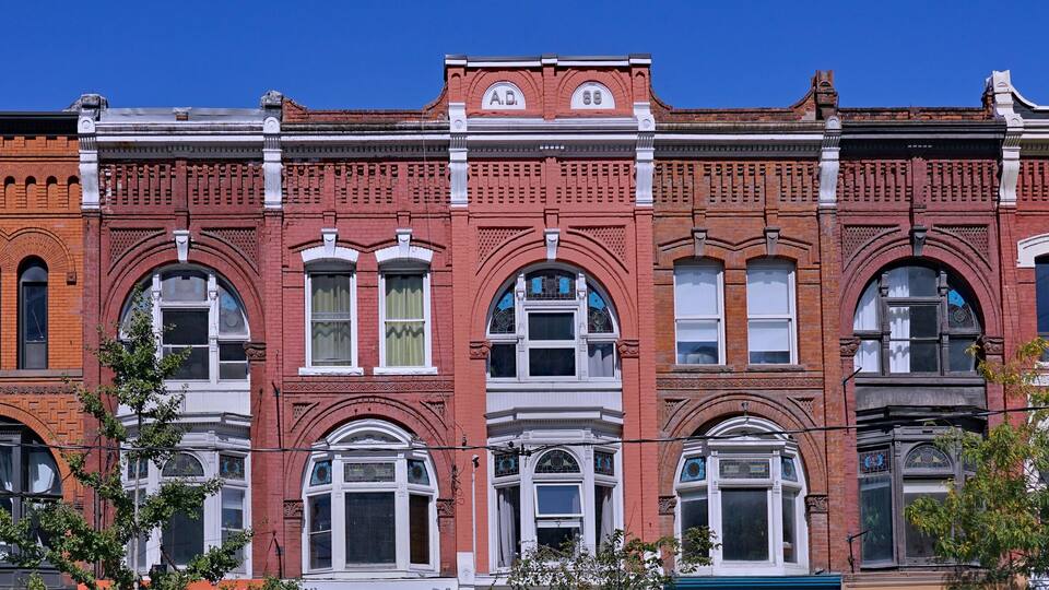 Block of ornate 19th century building facades in Toronto, Queen Street West, apartments above stores