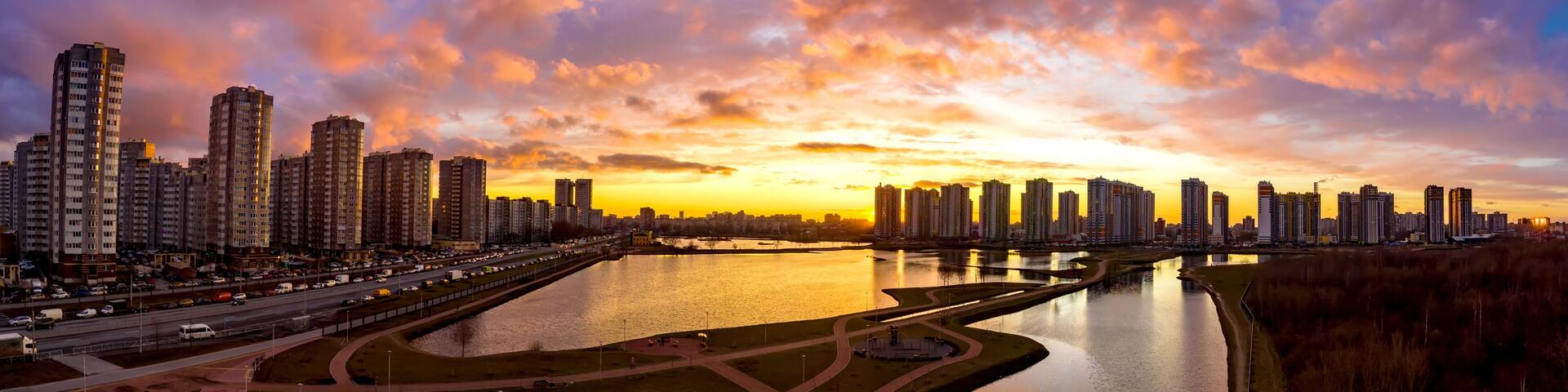 Saint Petersburg. Russia. High-rise buildings near pond. Architecture of Russian cities. Sleeping wound in St. Petersburg. Residential high-rise buildings. Sunset. Panorama of Russian city. Kupchino