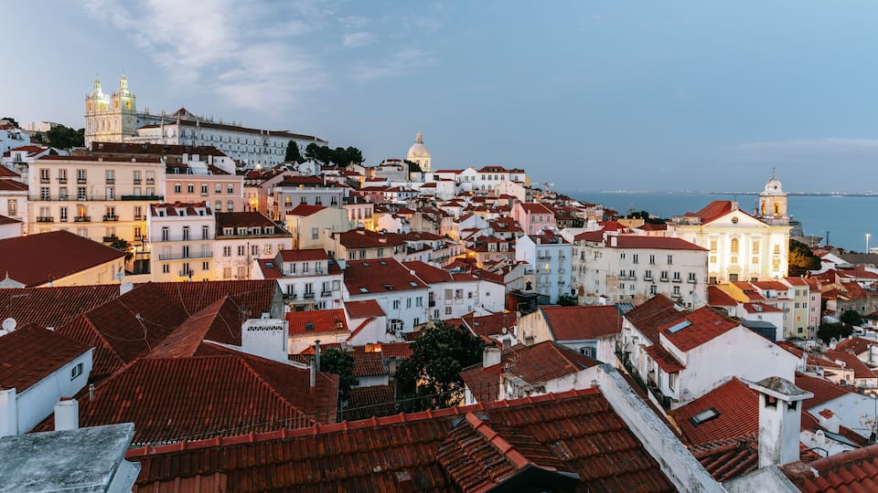 Paesaggio costiero con edifici storici, una chiesa importante e una struttura a cupola.