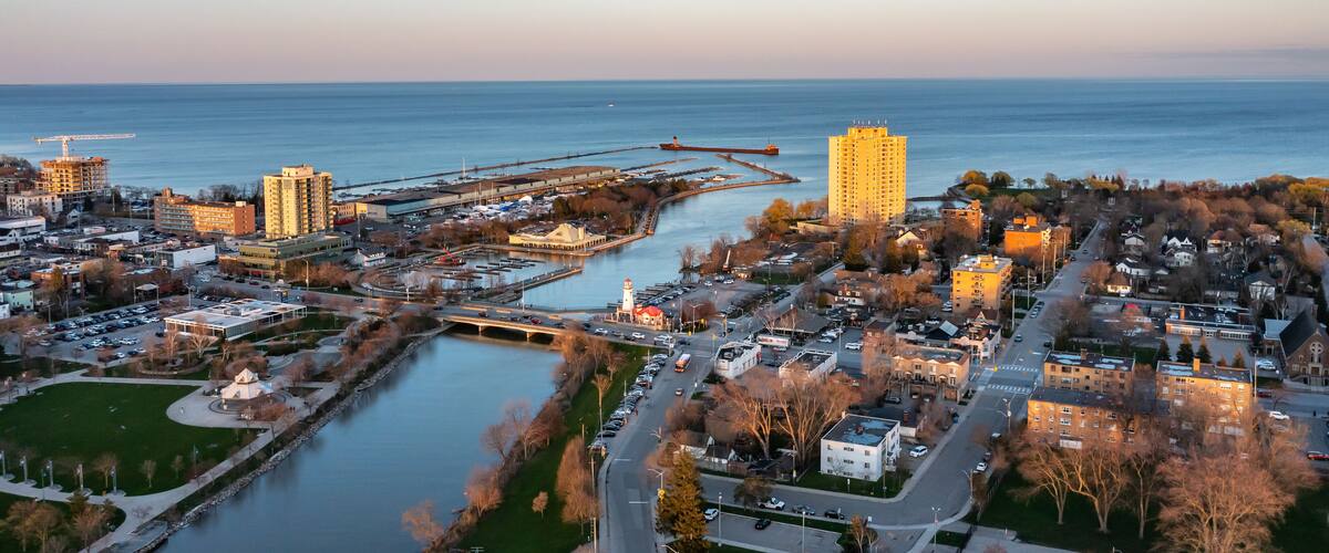 Aerial view of Port Credit at the mouth of the Credit River at sunset facing Lake Ontario in the summer.