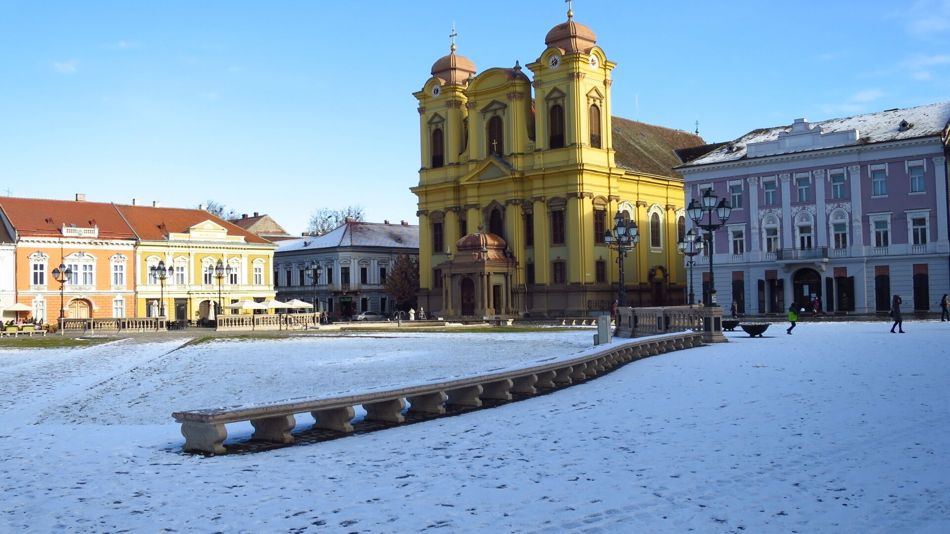 Timisoara - Catholic Dome in winter.

The Dome is the most important Baroque monument and also the most important Roman Catholic religious monument in the Banat region.
1. The Dome’s history is linked to the last battles with the Turks, the last Austro-Turkish war of 1788 to 1791. The Dome then served as a military depot, in particular a salt deposit.
2. During the 1849 siege, in the war between the young Hungarian Republic and the Austrian Monarchy, a projectile hit the Dome’s roof (at that time the artillery could not aim very precise), piercing the arch.

Although the church was filled with civilian refugees, there were no victims, an event considered at the time a true divine miracle.
Austrian Baroque, typical of “imperial edifices”. The towers are similar to those of the Holy Trinity Church in Salzburg, designed by Johann Bernhard Fischer von Erlach (father), one of the foremost architects in the service of the Habsburgs. Overall, the volume of the dome is more balanced than that church’s. 