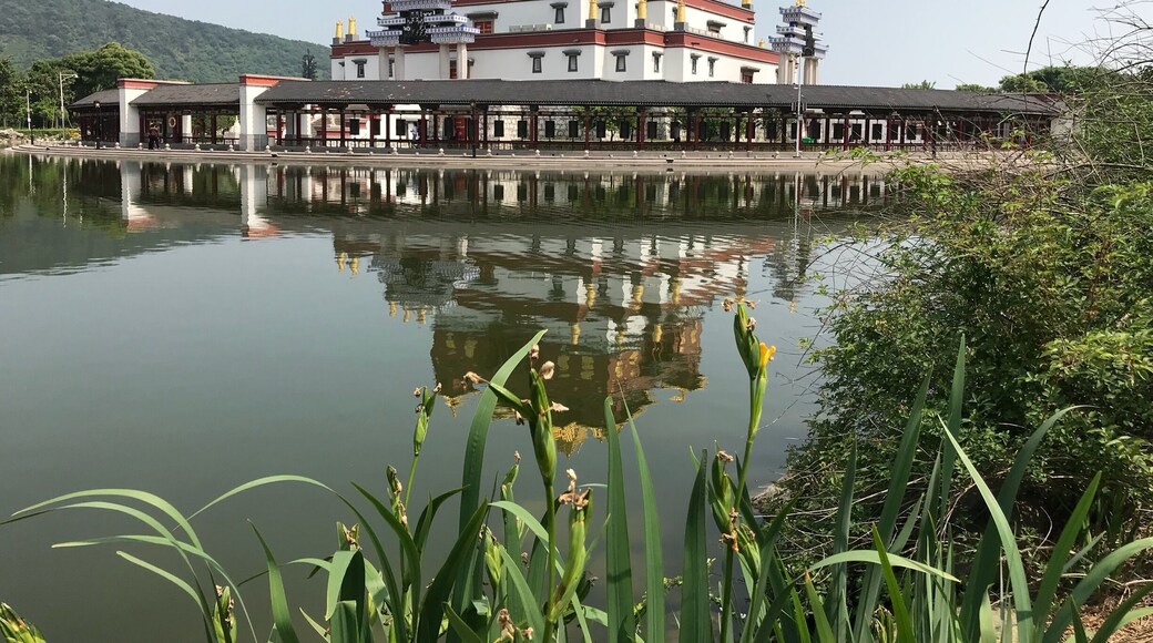 This is a picture of the Lingshan Shengjing Tibetan Buddhist inspired museum at the Ling Shan Scenic area near Wuxi, China. It sits on a small island in a small lake.
