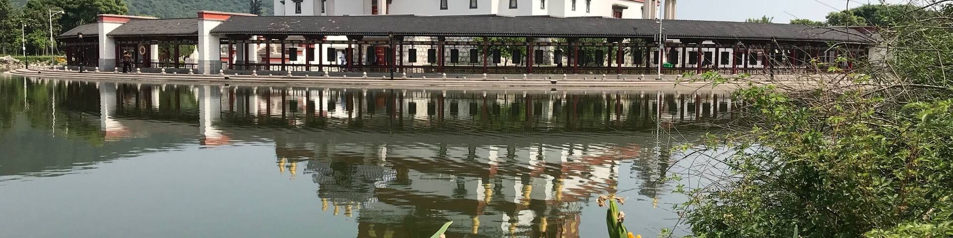 This is a picture of the Lingshan Shengjing Tibetan Buddhist inspired museum at the Ling Shan Scenic area near Wuxi, China. It sits on a small island in a small lake.