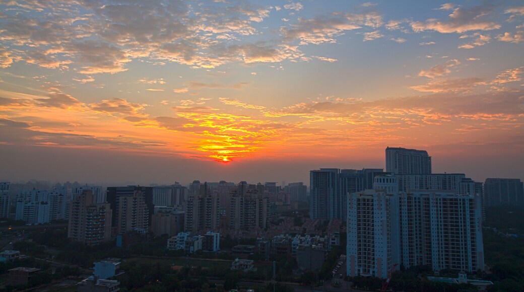 A city skyline at sunset with a vibrant sky and tall buildings.
