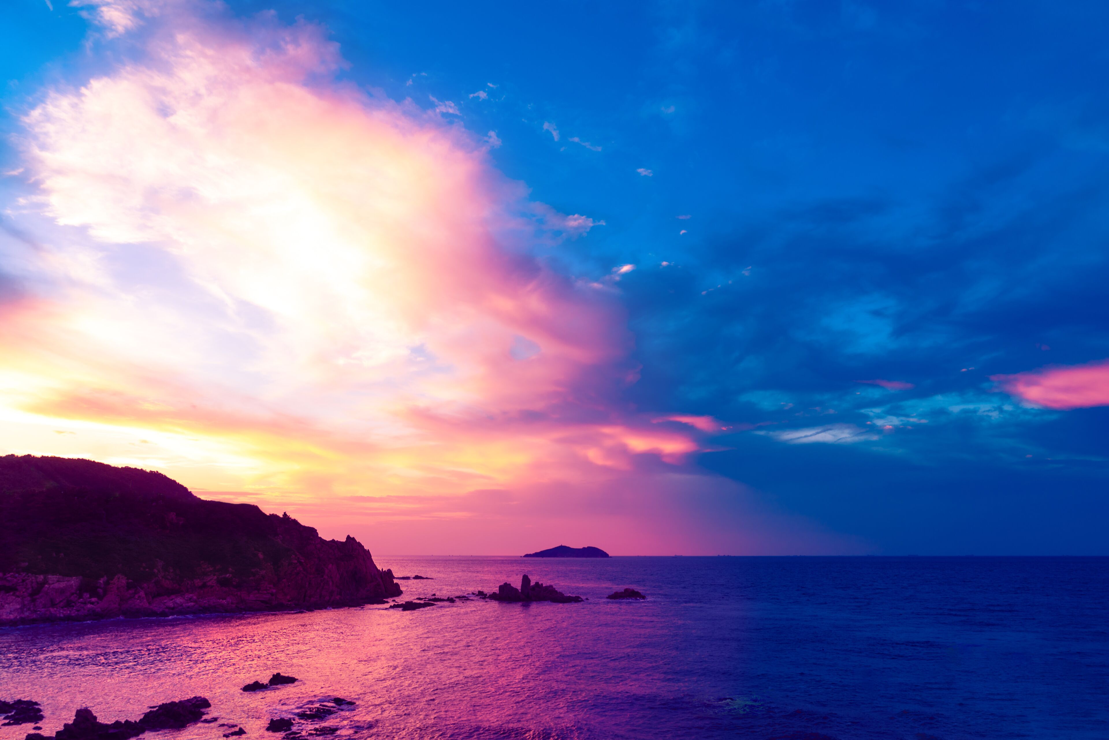 Chenghai Mountain, Weihai, Shandong, China, overlooking Donkey island Island Sunset Pink Sky.