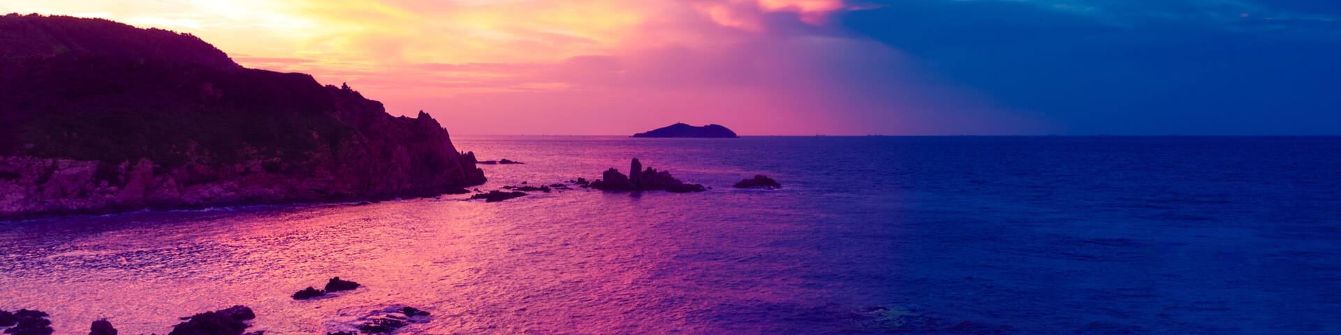 Chenghai Mountain, Weihai, Shandong, China, overlooking Donkey island Island Sunset Pink Sky.