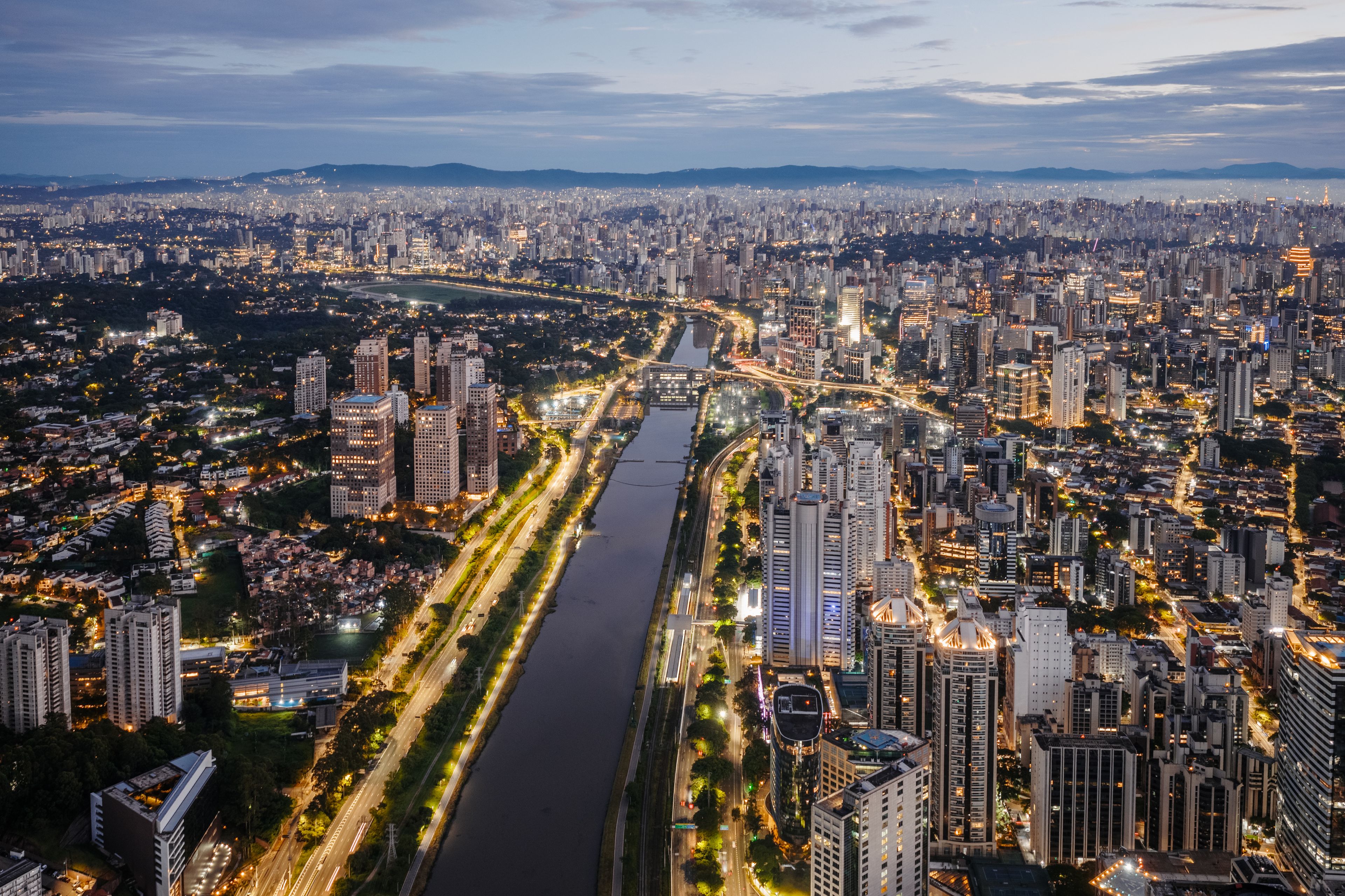 Aerial cityscape and Pinheiros River at dusk, Sao Paulo, Brazil