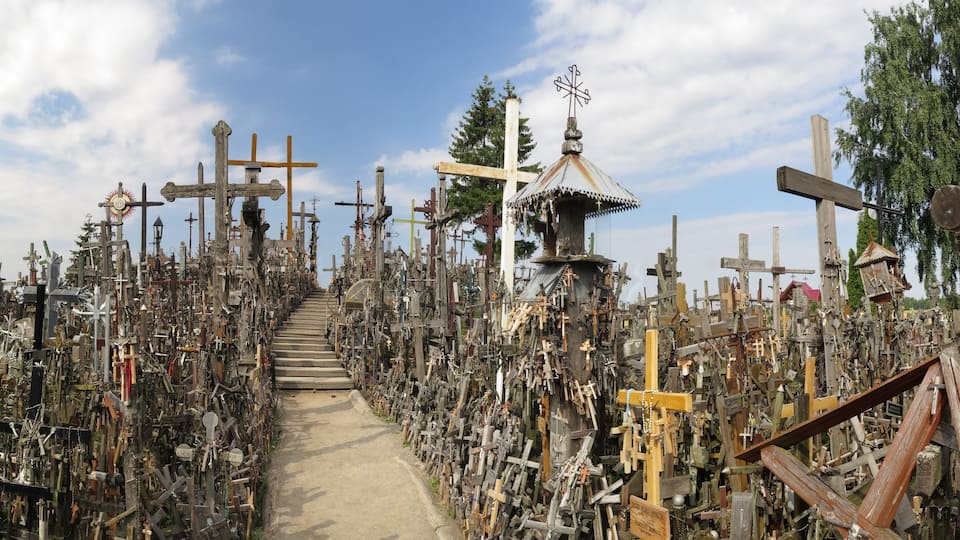 A cemetery filled with numerous crosses and memorials.