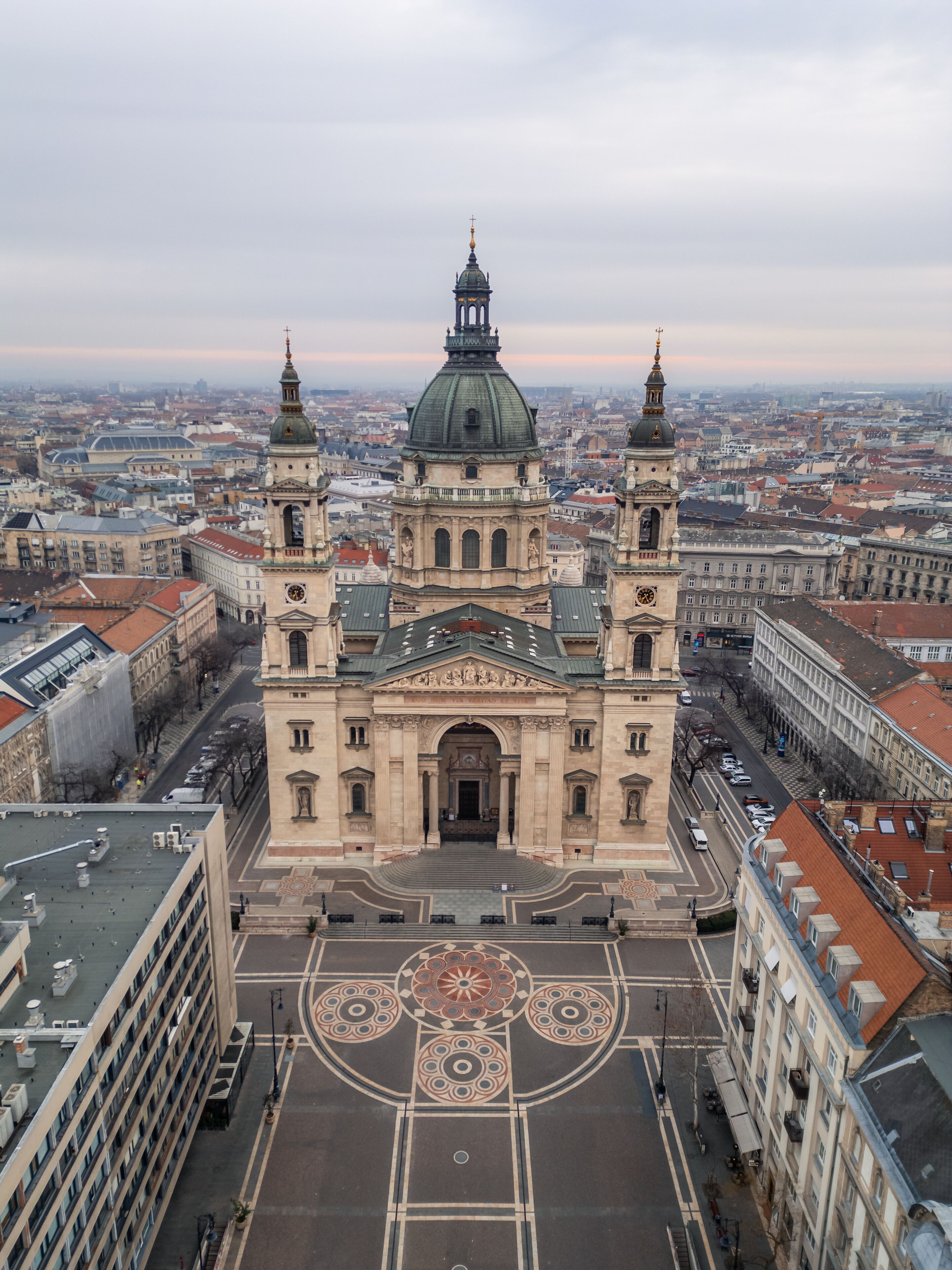 A large historic church with two towers and a dome, surrounded by a cityscape.