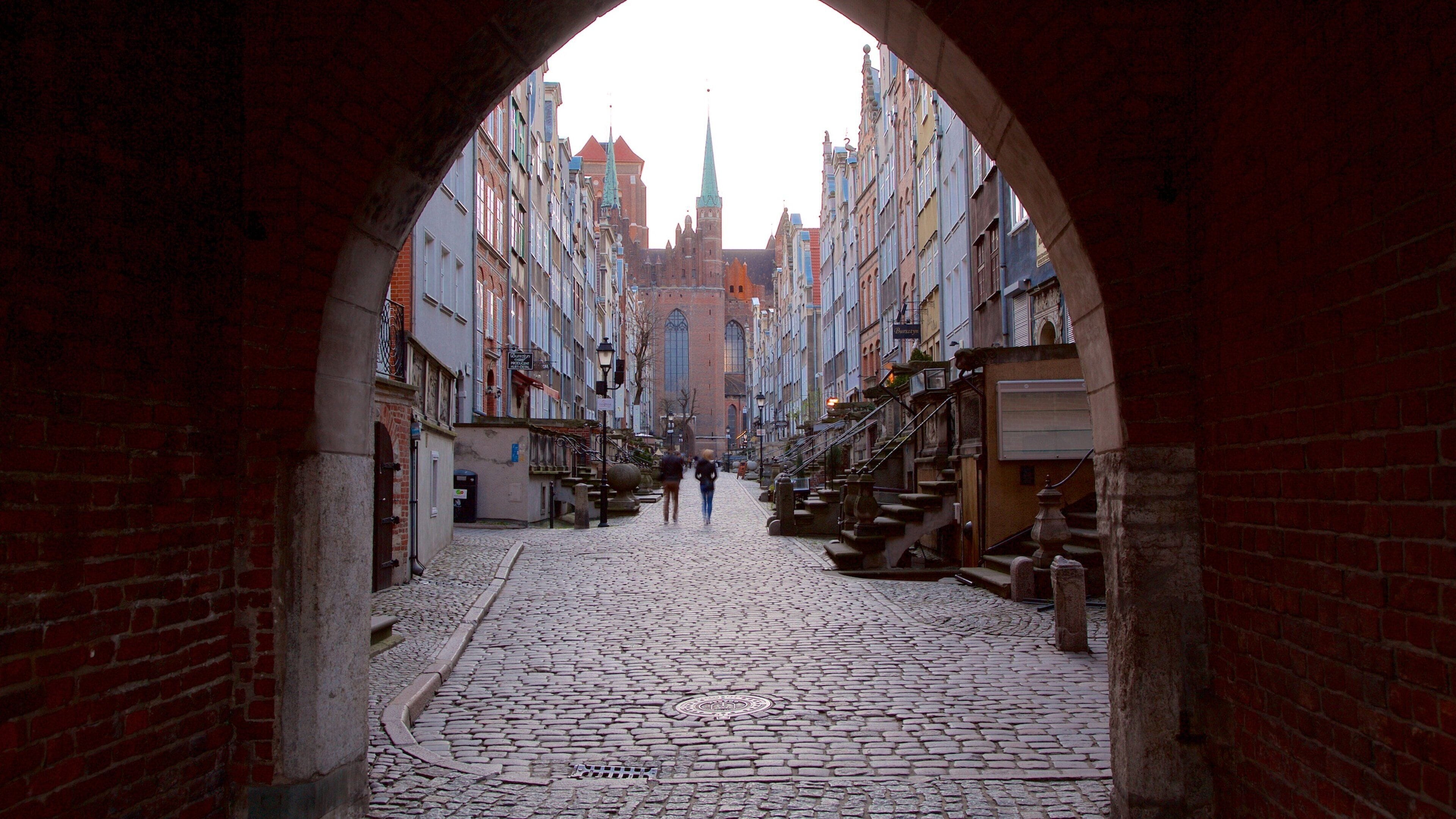 Old Town Gdańsk showing a city and night scenes as well as a couple