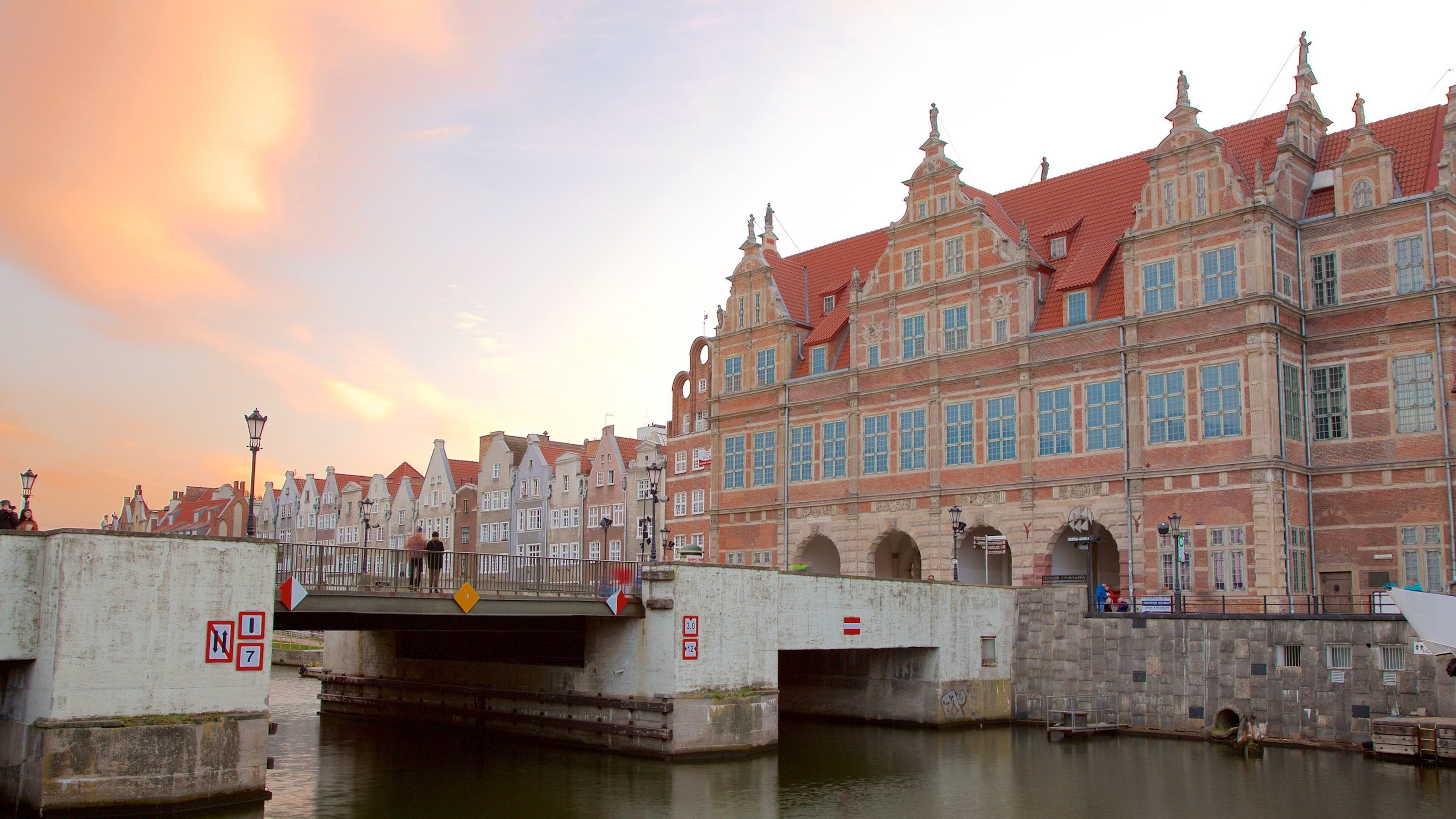 Old Town Gdańsk featuring heritage elements, a river or creek and a sunset