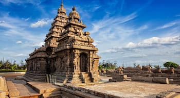 An ancient temple with intricate carvings and multiple spires, set against a clear blue sky.