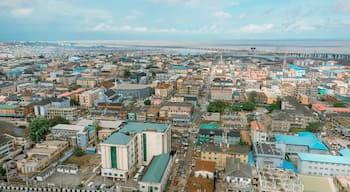 Aerial view of sprawling buildings and the Third Mainland Bridge stretching across the water, bathed in the soft light of day, Ikeja, Lagos, Nigeria.