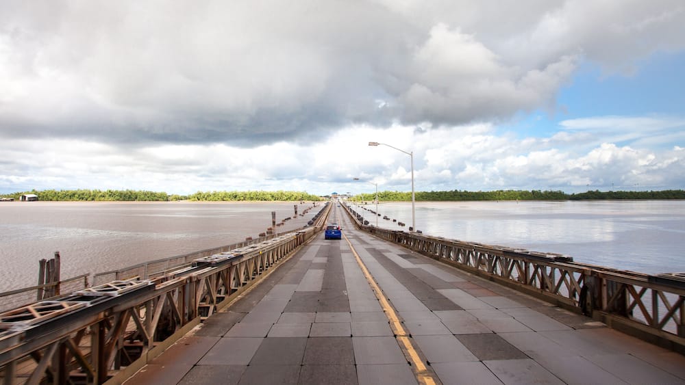 View of the pontoon bridge over the Demerara harbour bridge on a clear Sunny day before a thunderstorm, Guyana. World tourism, attractions, landscape.
