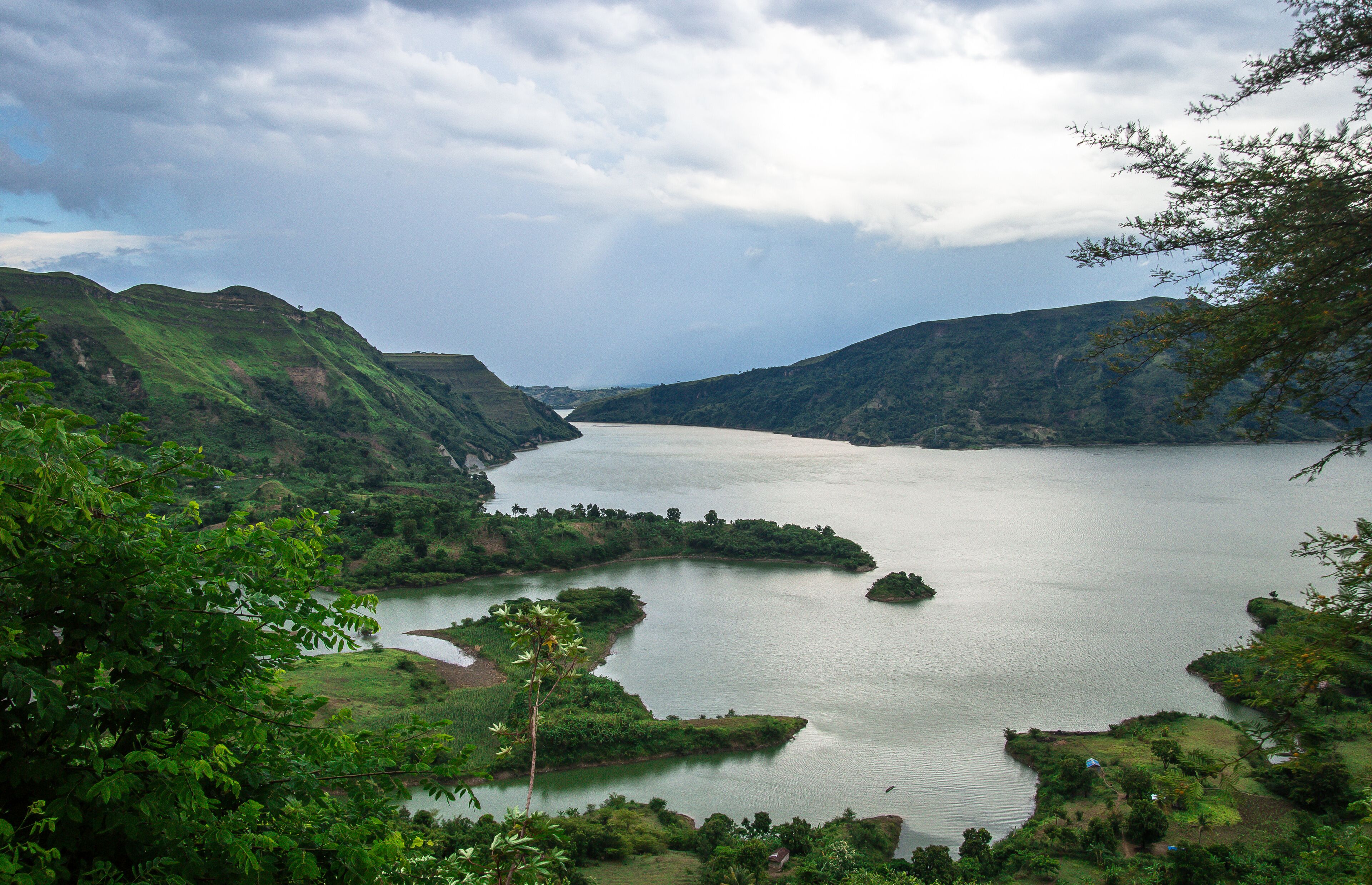 A river winding through a lush valley with hills on either side.