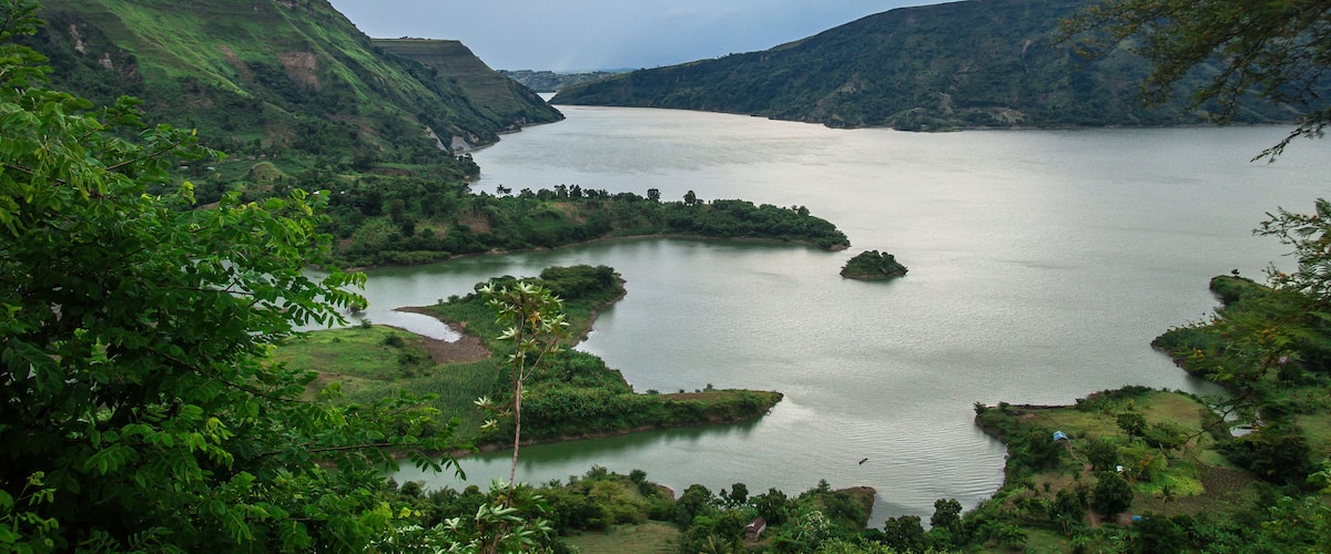 A river winding through a lush valley with hills on either side.