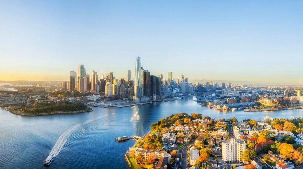 A cityscape with a prominent bridge, high-rise buildings, and a river.