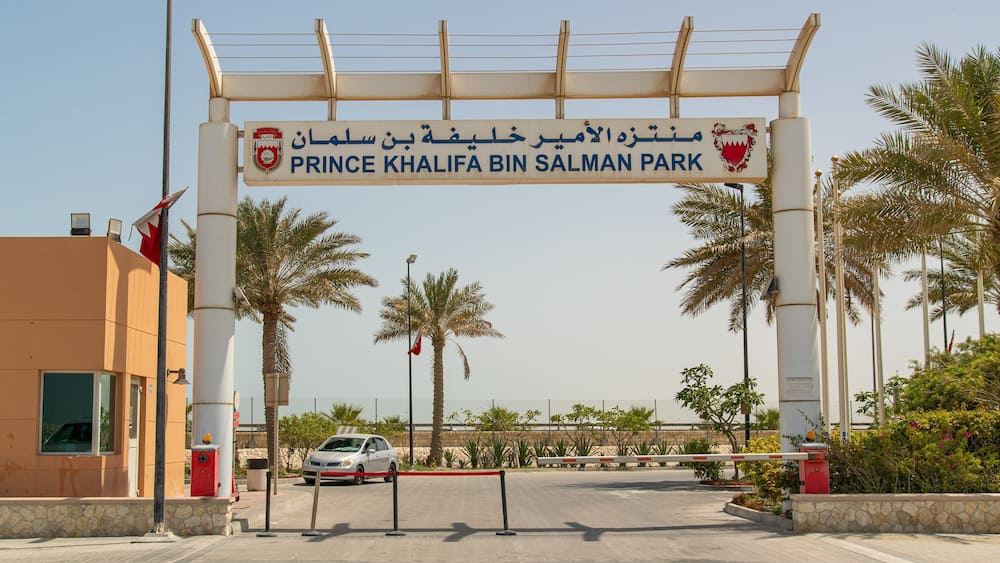 Prince Khalifa Bin Salman Park featuring a coastal town and signage