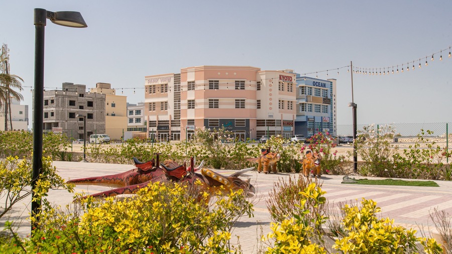 Prince Khalifa Bin Salman Park which includes a coastal town and flowers