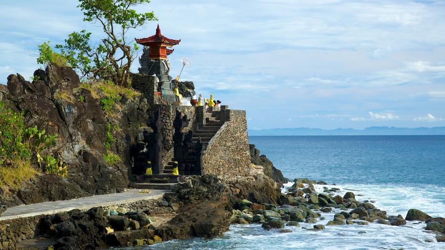 Lombok featuring religious aspects, rocky coastline and a temple or place of worship