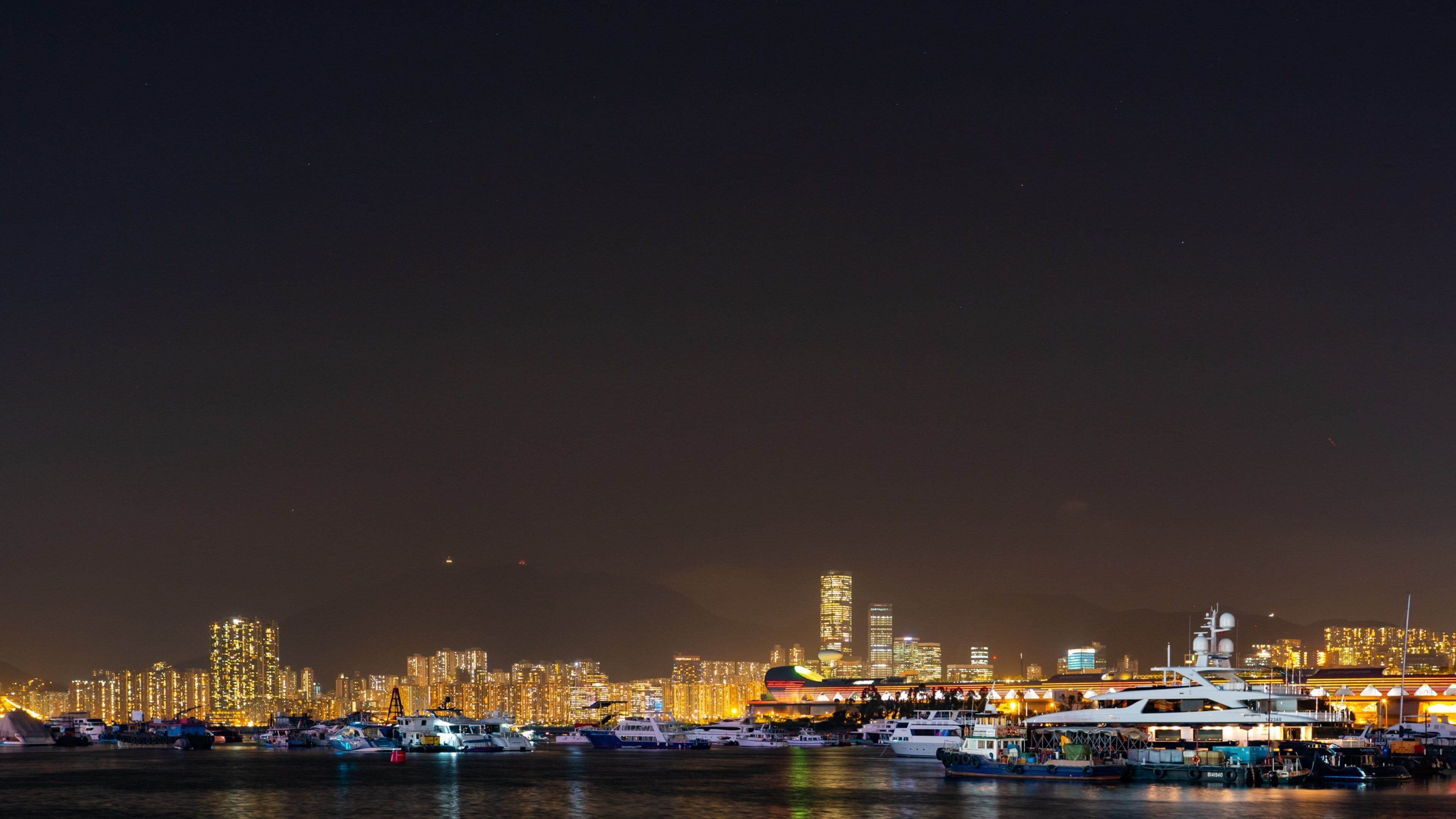 Kwun Tong Promenade featuring a bay or harbor, a city and night scenes