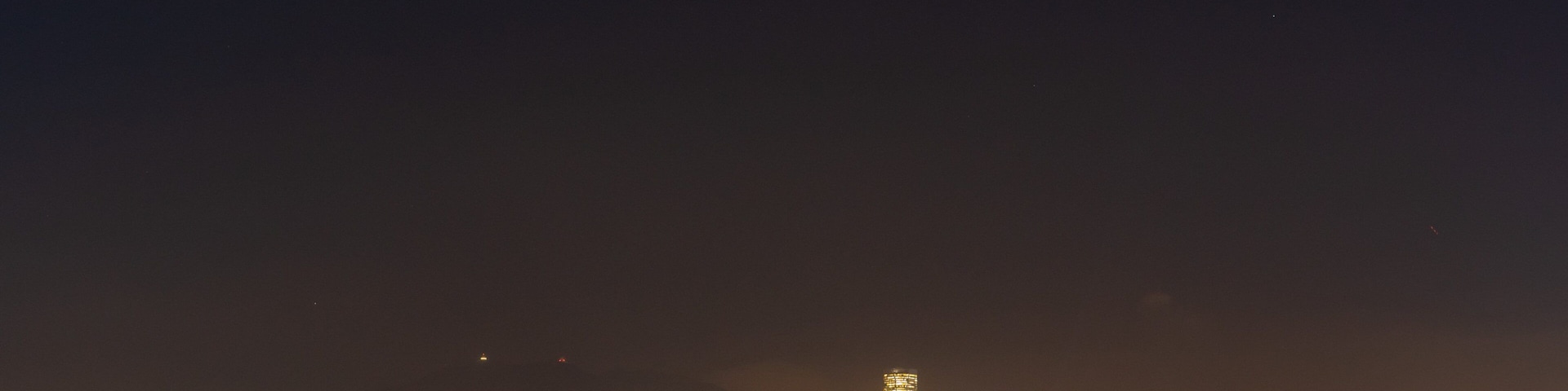 Kwun Tong Promenade featuring a bay or harbor, a city and night scenes