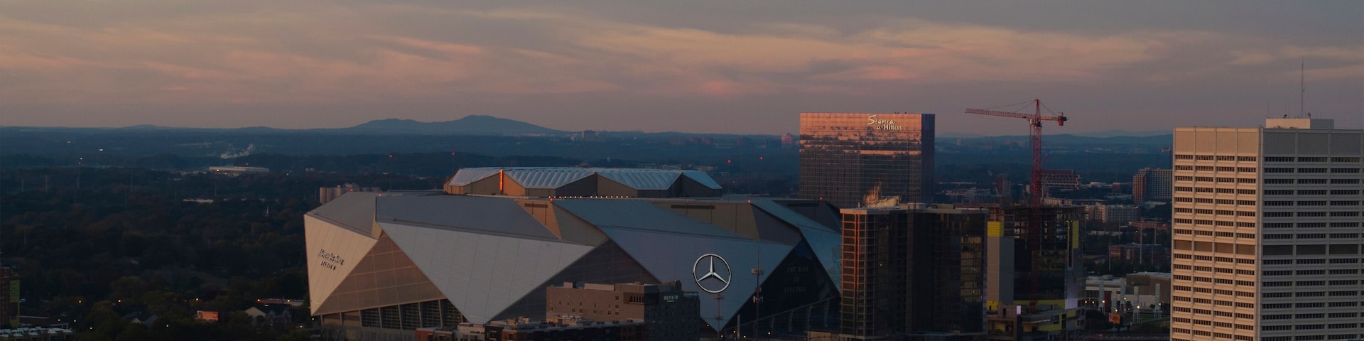 Atlanta, United States - 17 November 2024: Aerial view of mercedes-benz stadium and vibrant skyline at dusk, downtown, atlanta, georgia, united states.