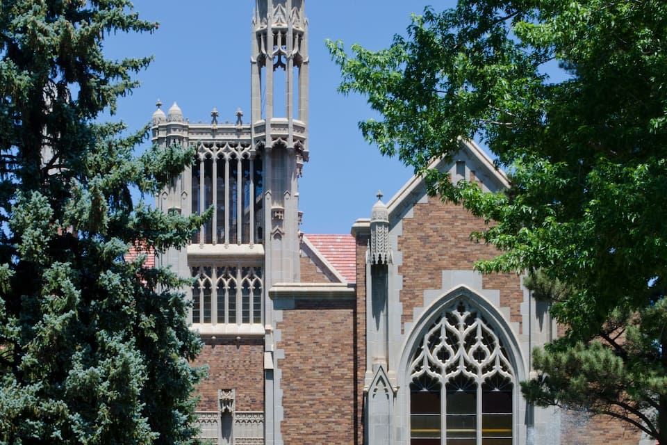 A Gothic-style church with a tall tower and arched windows.
