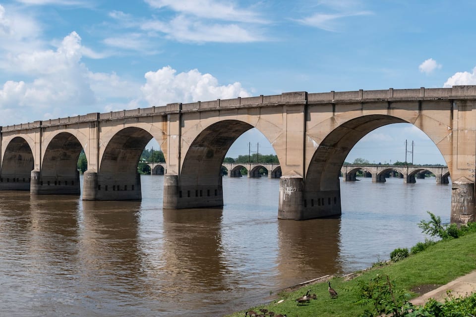 A long stone bridge with multiple arches spanning a river.