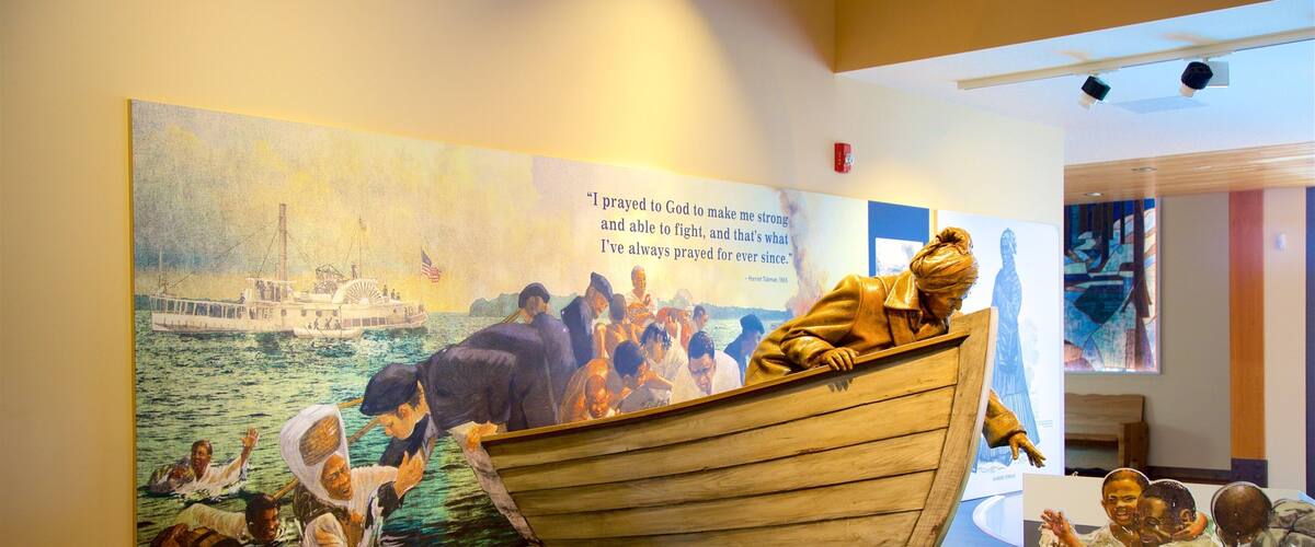 A mural of a boat with people and a quote about praying to God.