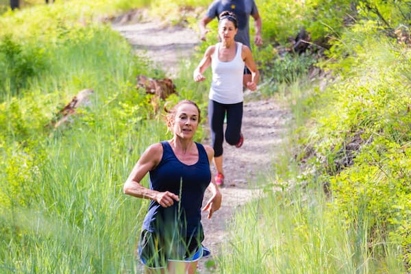 People running the Lion Mountain Trailhead section of 'The Whitefish Trail', Whitefish, Glacier Country, Montana, USA.