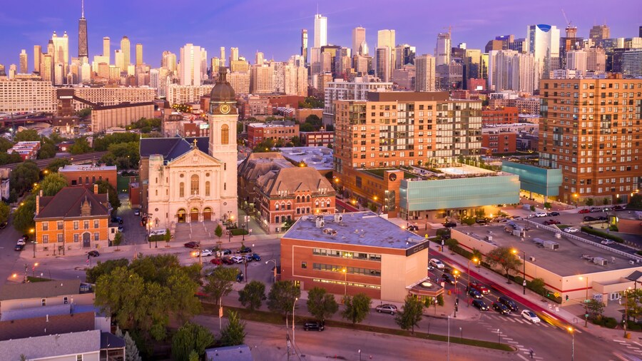 Chicago cityscape at twilight, featuring a mix of residential and commercial buildings, including a church and modern apartment complex. River West, Chicago, Illinois, United States