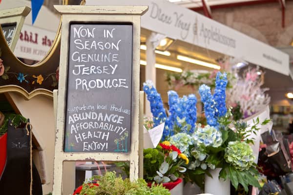 St. Helier Central Market showing flowers, markets and signage