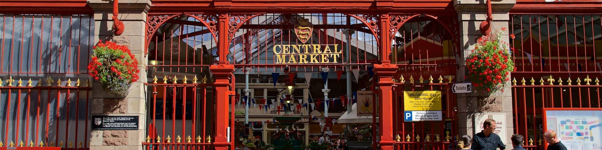 The entrance to Central Market with ornate red gates and hanging flower baskets.