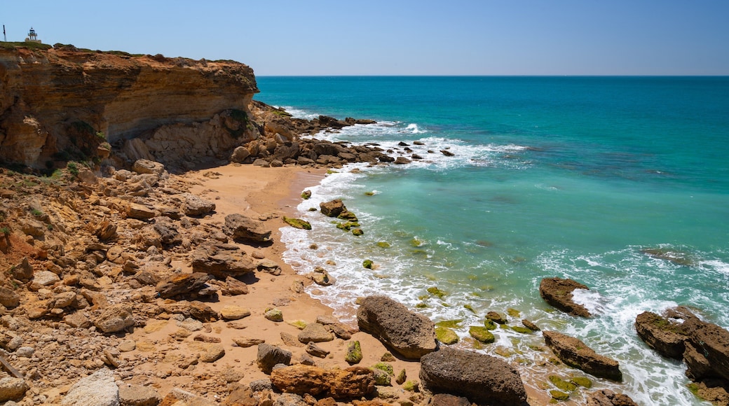 Cala del Faro which includes a beach, rocky coastline and general coastal views
