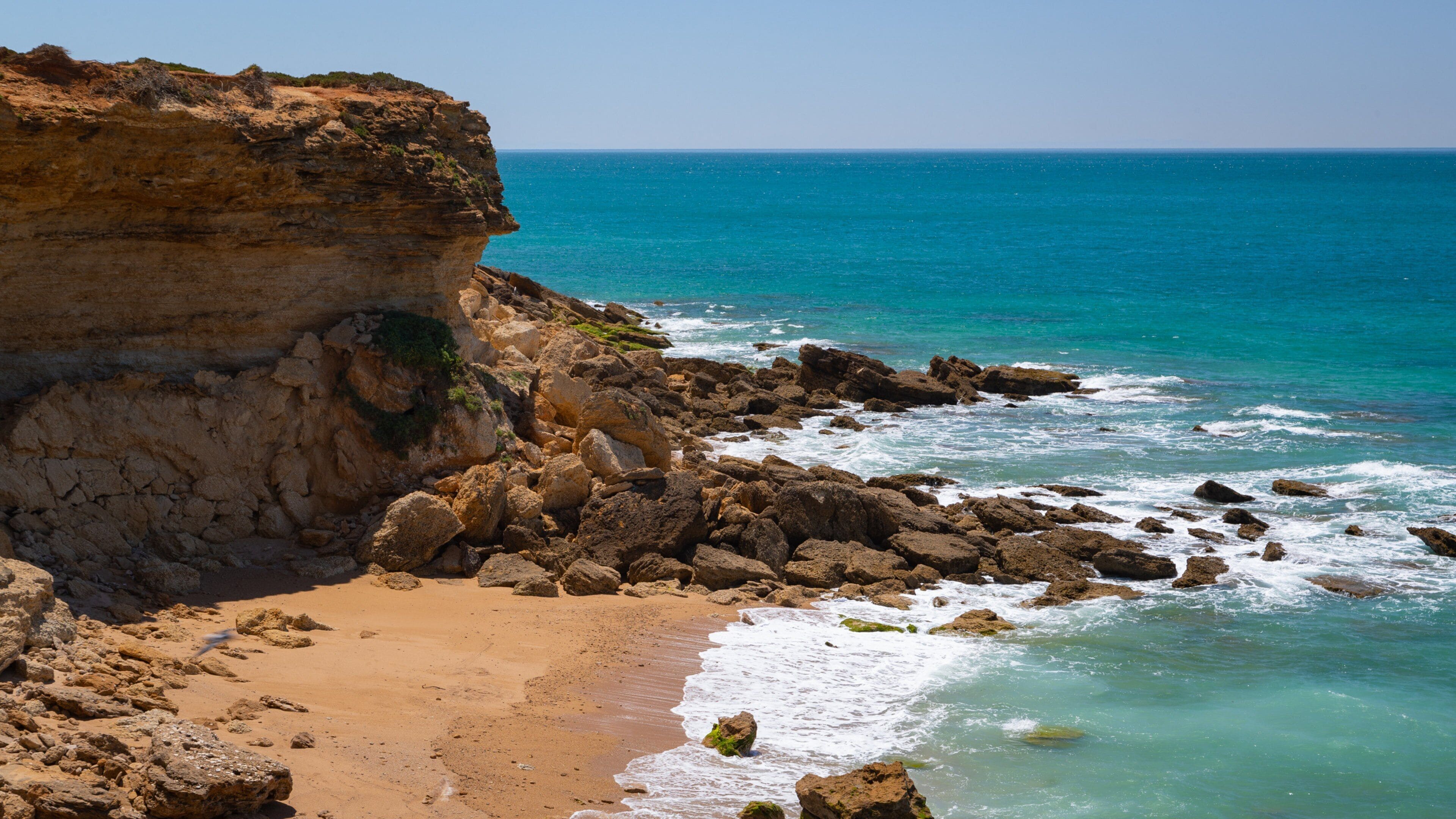 Cala del Faro featuring a beach, general coastal views and rugged coastline