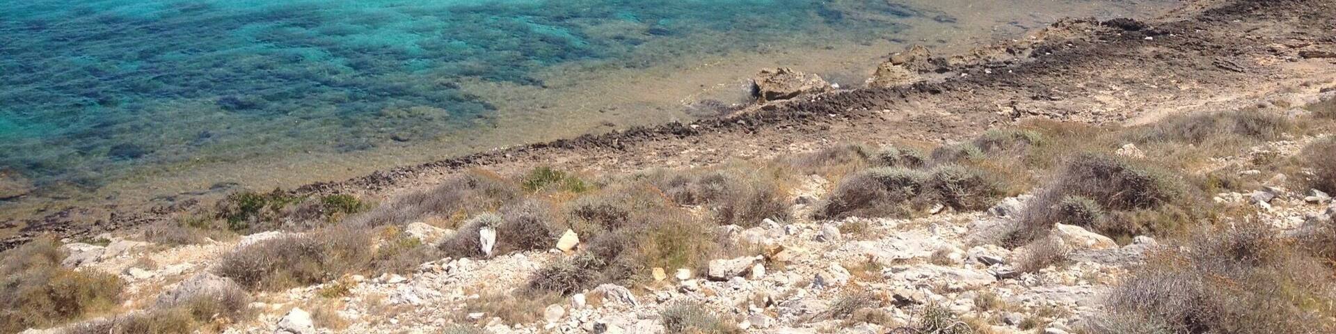 This beach is located west of the beach Cala Mesquida, you can reach the beach only by a gravel road
