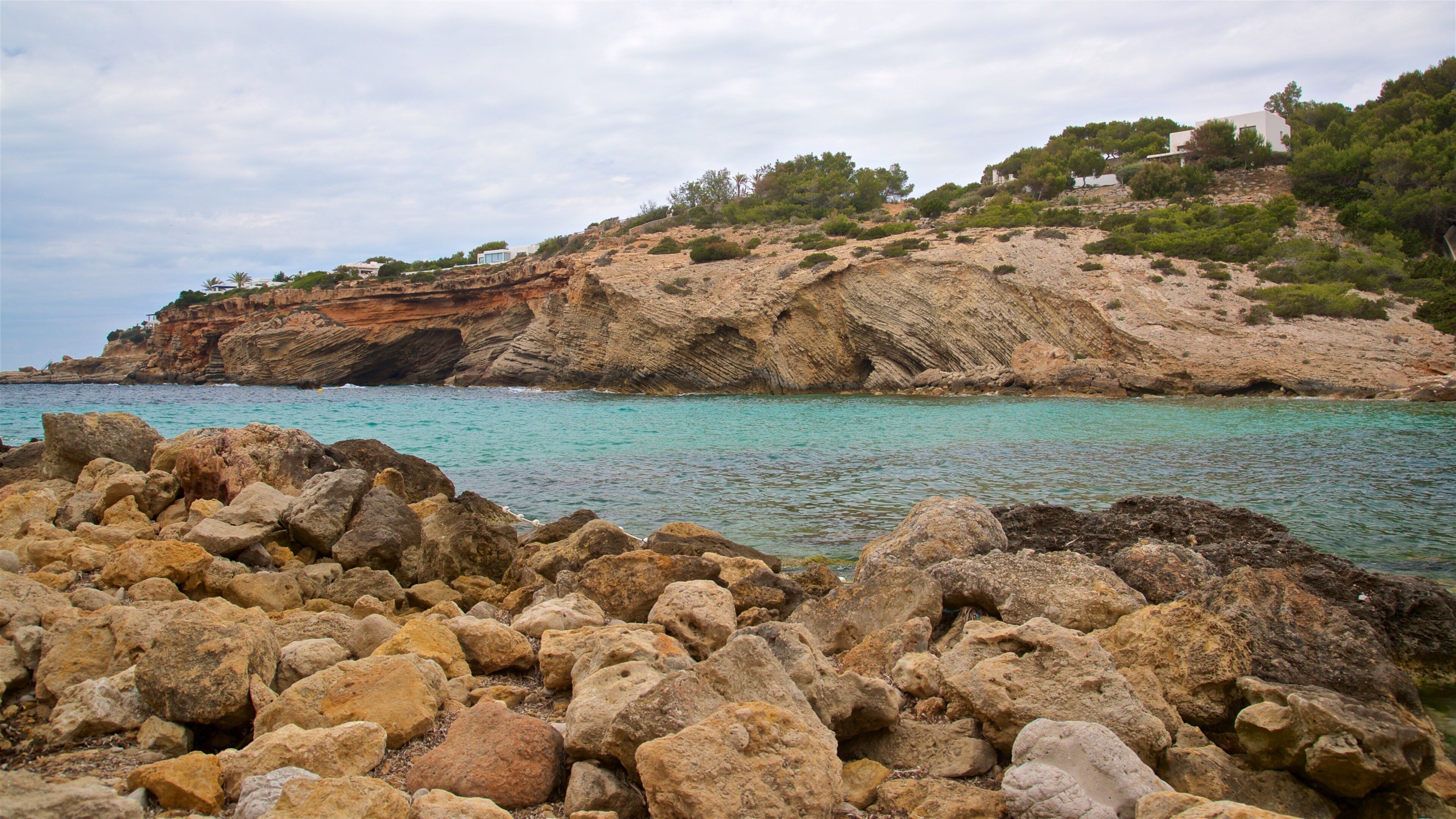Cala Codolar featuring rocky coastline and general coastal views