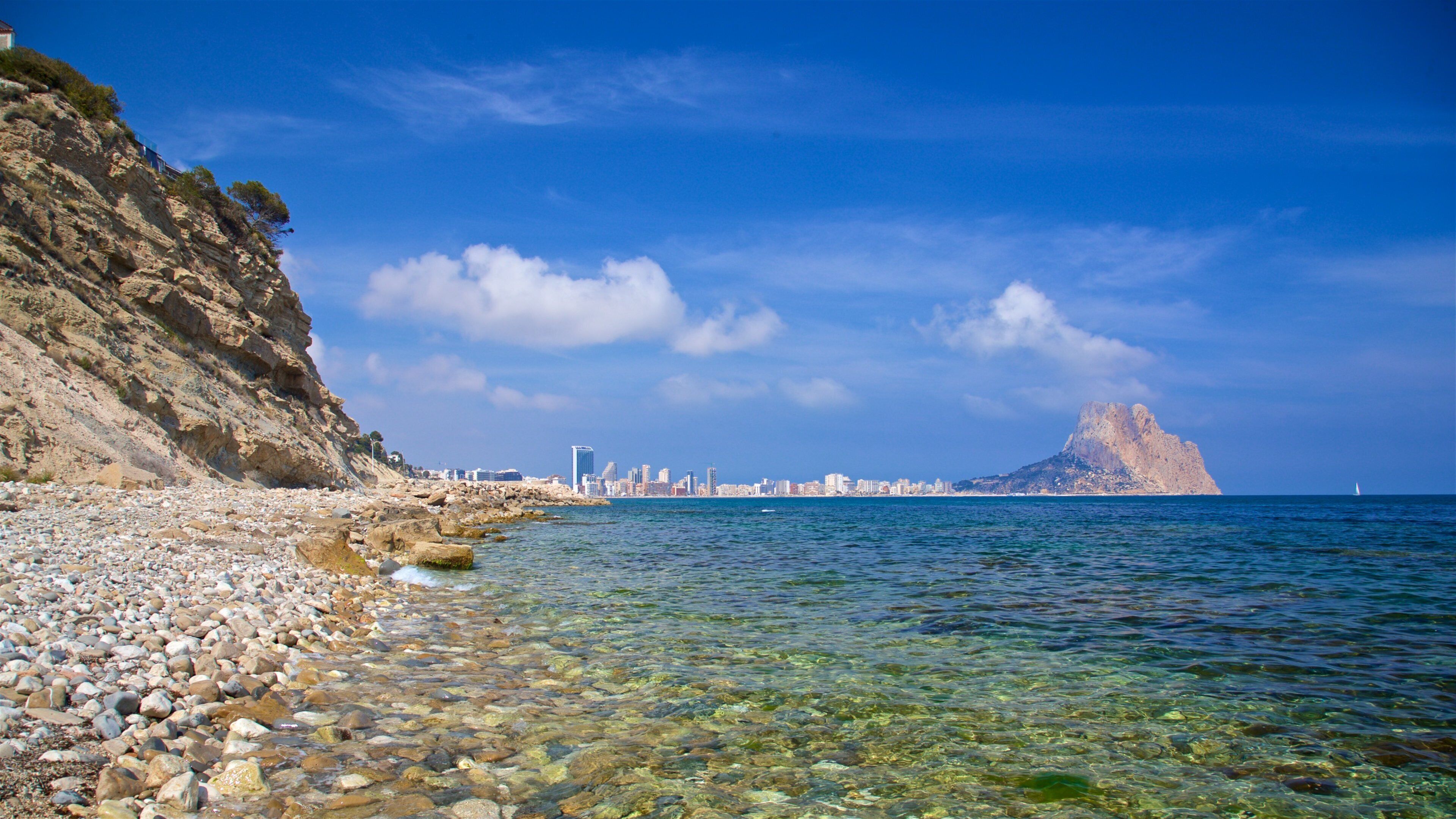 Cala Les Urques which includes general coastal views and a pebble beach
