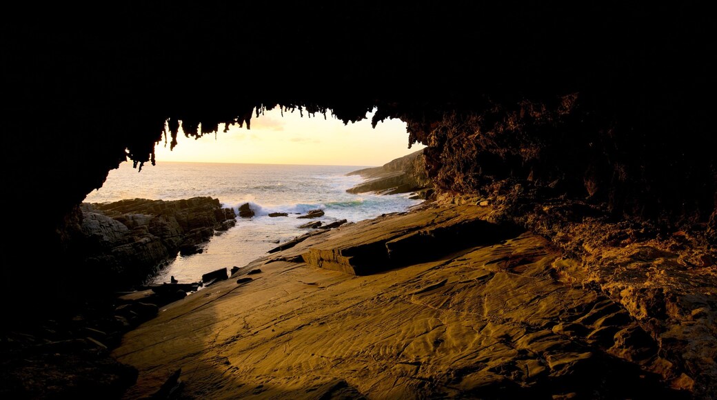 Admirals Arch featuring a sunset, caves and general coastal views