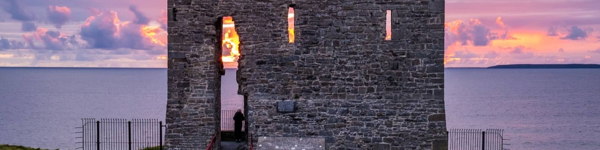 Sunset behind old castle ruins. Ballybunion, Co. Kerry, Ireland.