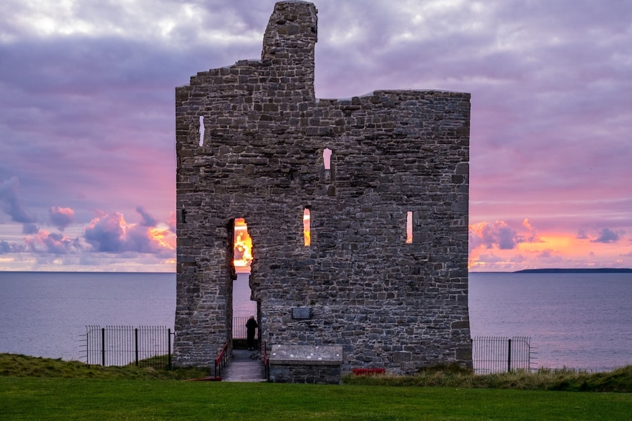 Sunset behind old castle ruins. Ballybunion, Co. Kerry, Ireland.