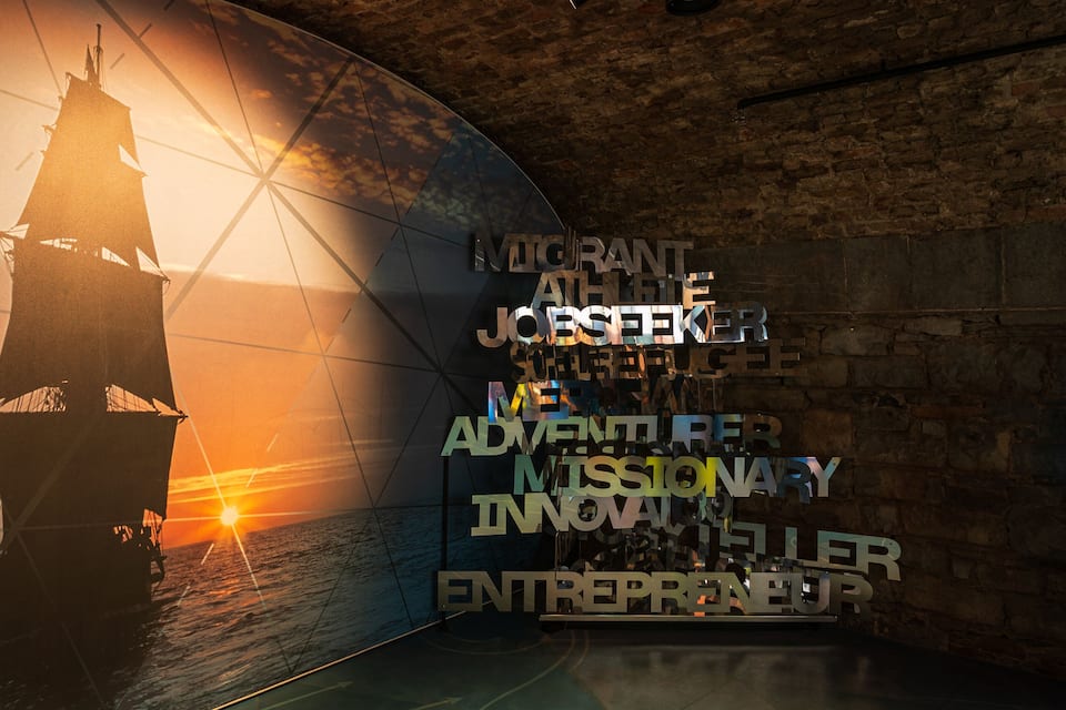 A lighthouse silhouette against a sunset, with a wall displaying the text "MORANT ADVENTURE JOSEKIER ADVENTURE MISSIONARY INNOVATOR ENTREPRENEUR".