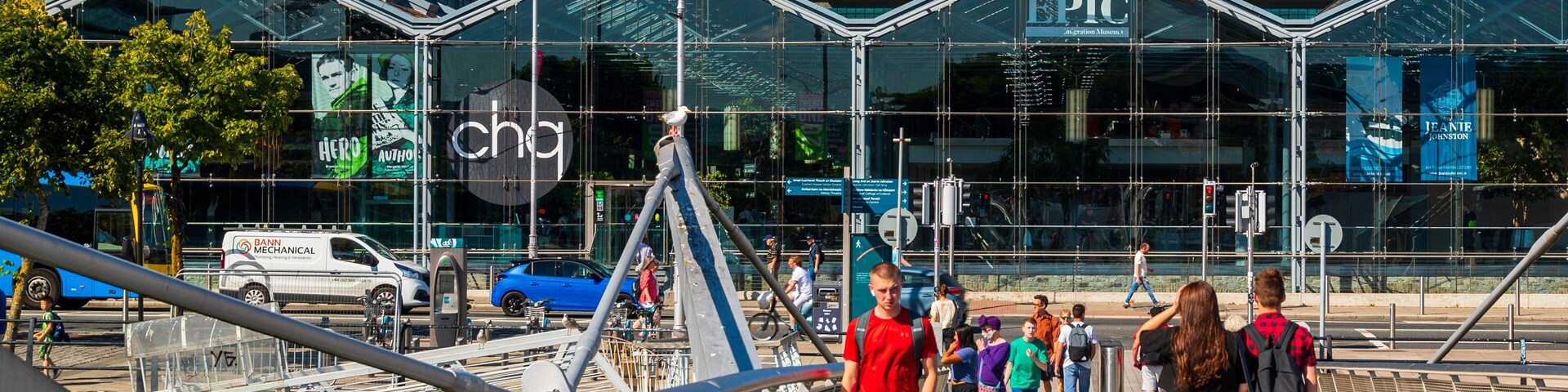 A pedestrian bridge with a glass building in the background labeled "PIC" and "JEANIE JOHNSTON".
