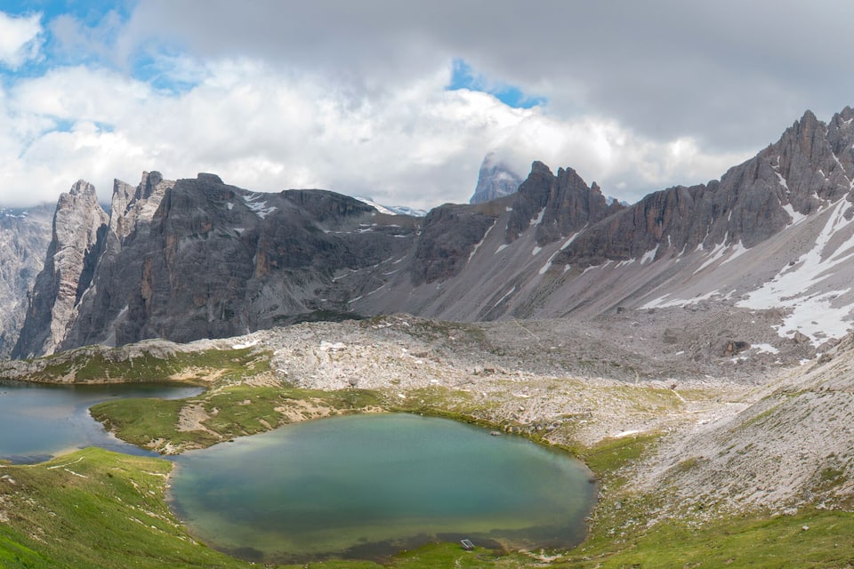 A mountainous landscape with two lakes and rugged peaks.