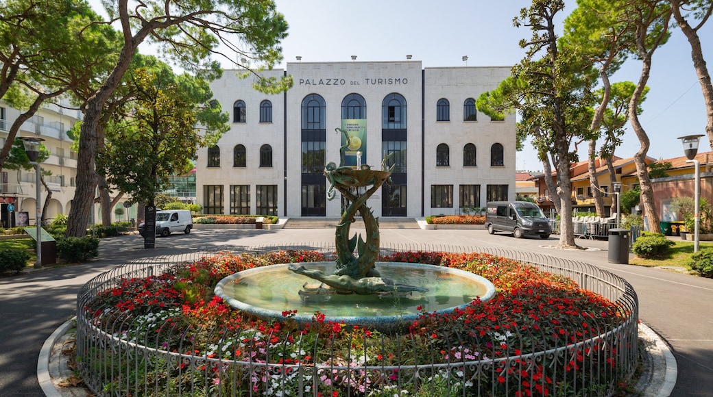 Palazzo Del Turismo featuring flowers and a fountain