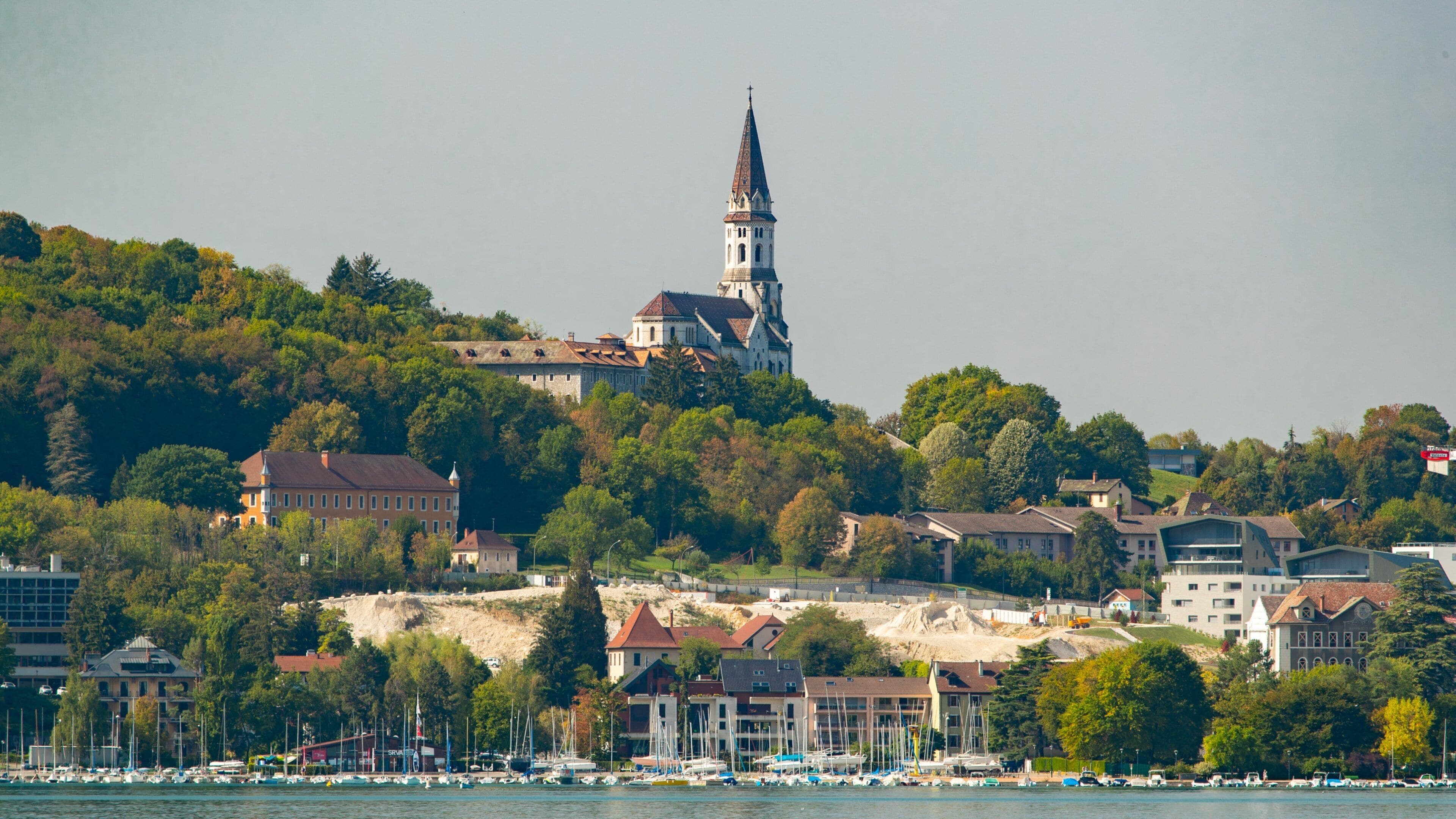 Basilique de la Visitation featuring a small town or village and a bay or harbor