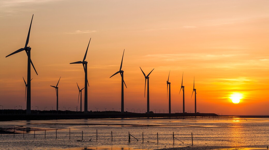 sunset view of Gaomei wetlands landscape and the wind power plant in Taichung, Taiwan. energy systems and renewable energy.